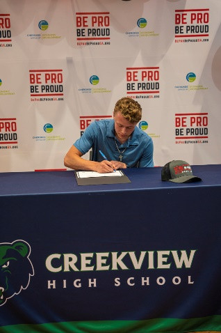 Creekview sophomore Will Nichelson signing certificate during Signing Day